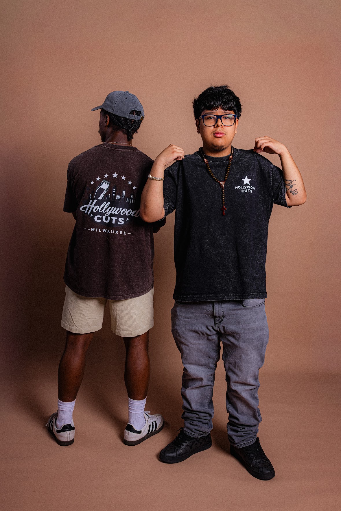 Washed black and brown Hollywood Cuts shirts showing the front and back designs